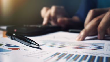 Close up pen on paperwork and woman hand calculate finance.