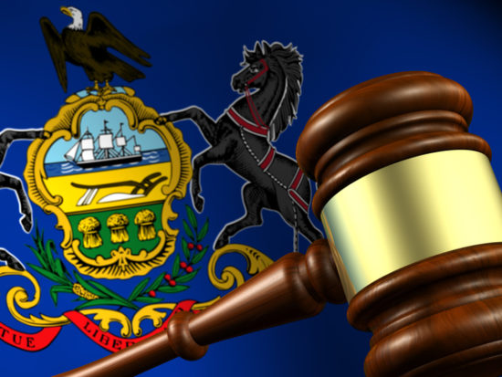 Pennsylvania state laws, legal system and justice concept with a 3D rendering of a gavel and the Pennsylvanian flag on background.