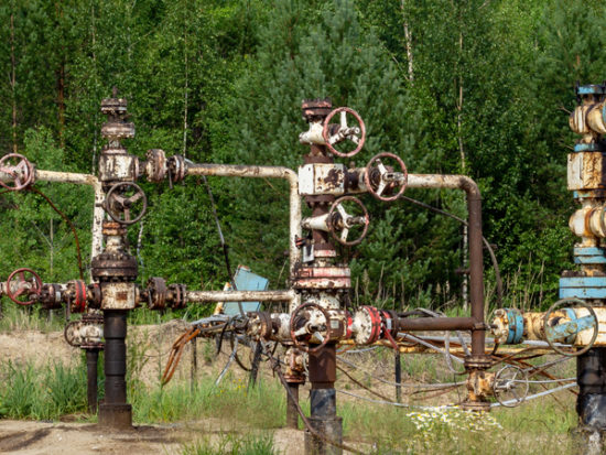 old abandoned wells on the background of the forest