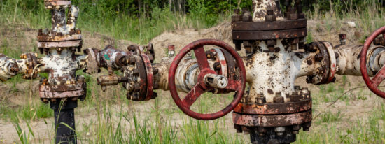 old abandoned wells on the background of the forest-shutterstock_1614961423