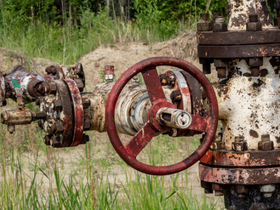 old abandoned wells on the background of the forest-shutterstock_1614961423