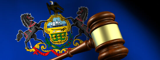 Pennsylvania state laws, legal system and justice concept with a 3D rendering of a gavel and the Pennsylvanian flag on background.