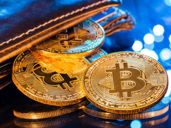 Bitcoin gold coins with wallet, close-up Virtual cryptocurrency concept