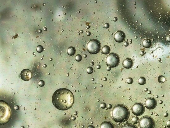 Beautiful and fantastic macro photo of water droplets in oil with a clear background.