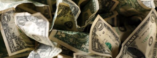 close up wrinkled American one dollar bills pile-Shutterstock_1434855290