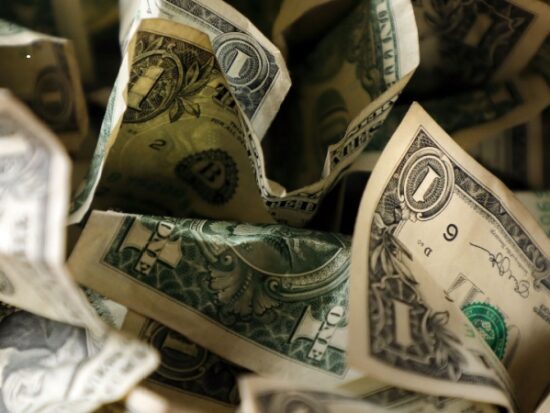 close up wrinkled American one dollar bills pile-Shutterstock_1434855290