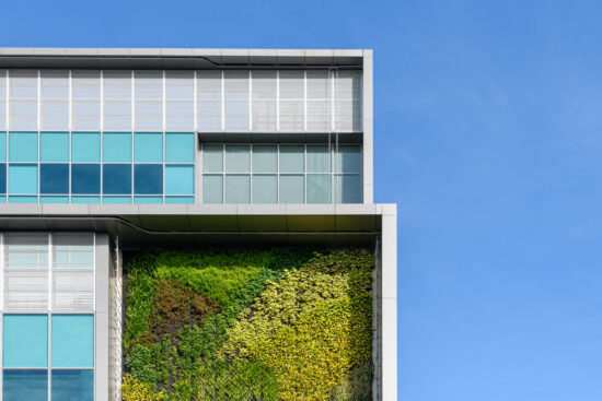Modern green building with innovative high rise vertical garden