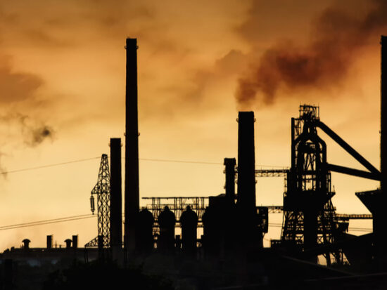Smokestack-in-factory-with-yellow-sky-and-clouds.-Industrial-pollution.