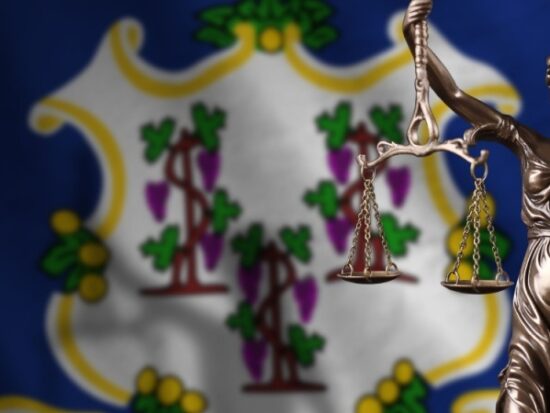 Connecticut state flag with scales of justice-Shutterstock_2225233075