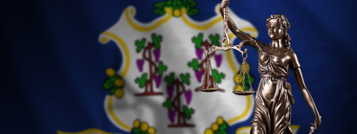 Connecticut state flag with scales of justice-Shutterstock_2225233075