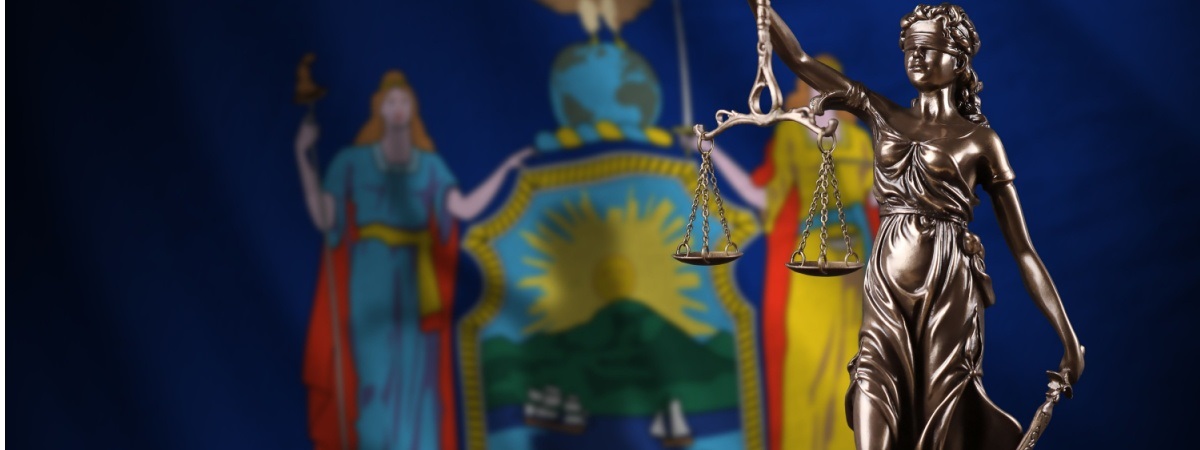 New York US state flag with statue of lady justice and judicial scales-Shutterstock_2242551935