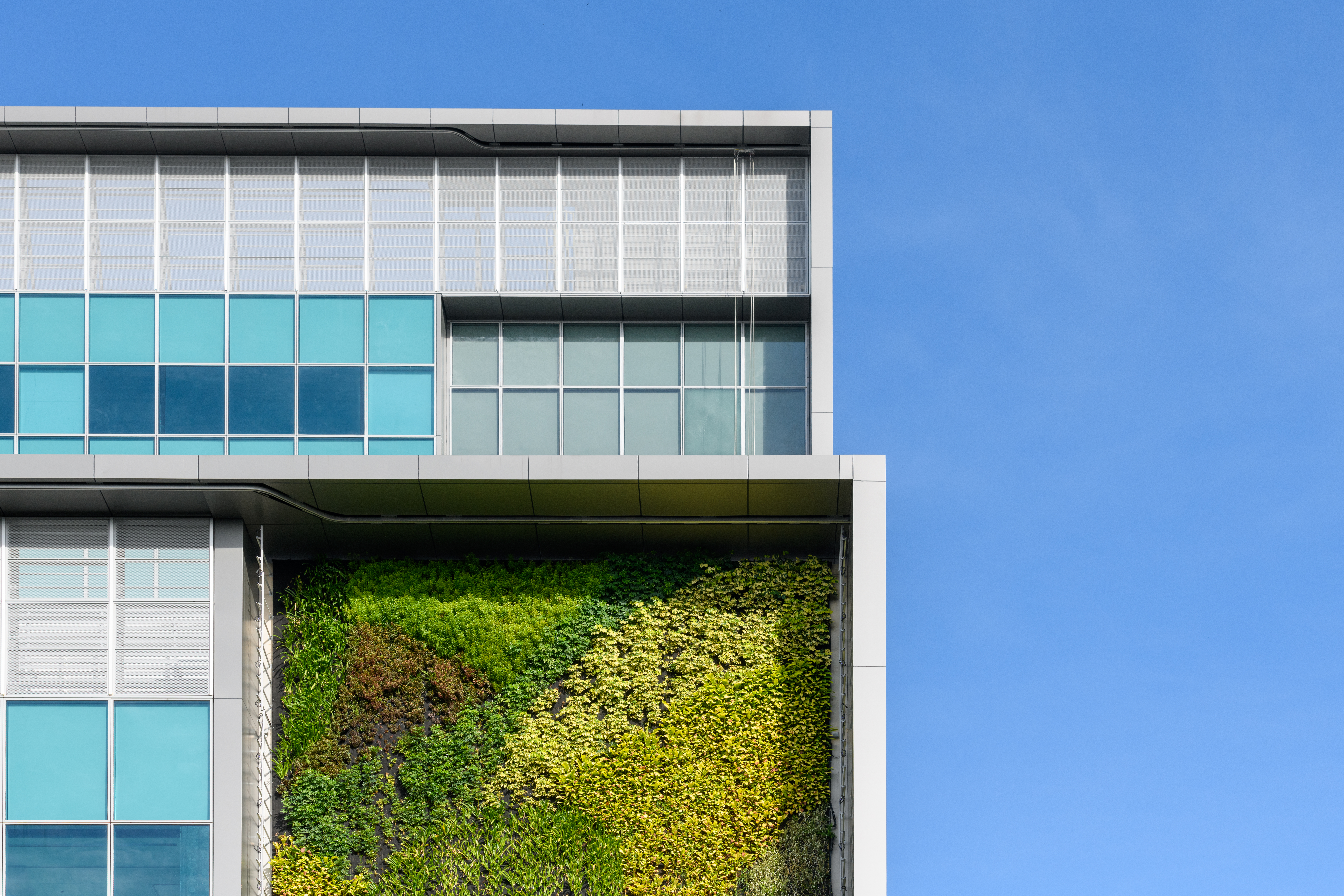 Modern green building with innovative high rise vertical garden